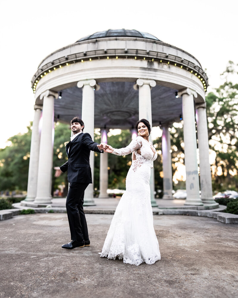Bride and groom dance in front of Popp Bandstand in City Park 