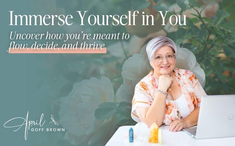 April poses at desk with a background of peach flowers
