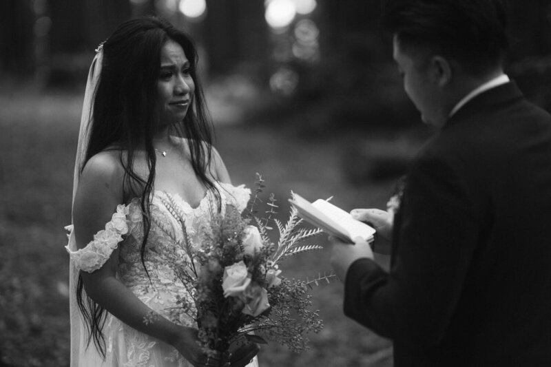 Bride sheds a tear while she listens to groom's vows during their elopement ceremony 