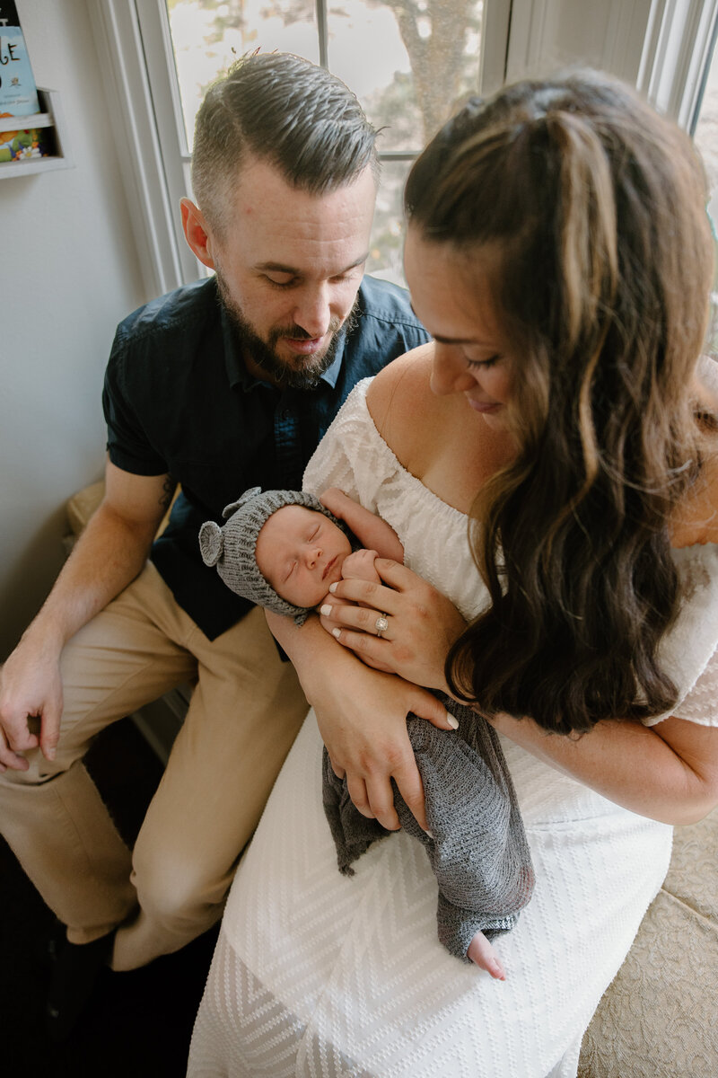 mom and dad holding newborn