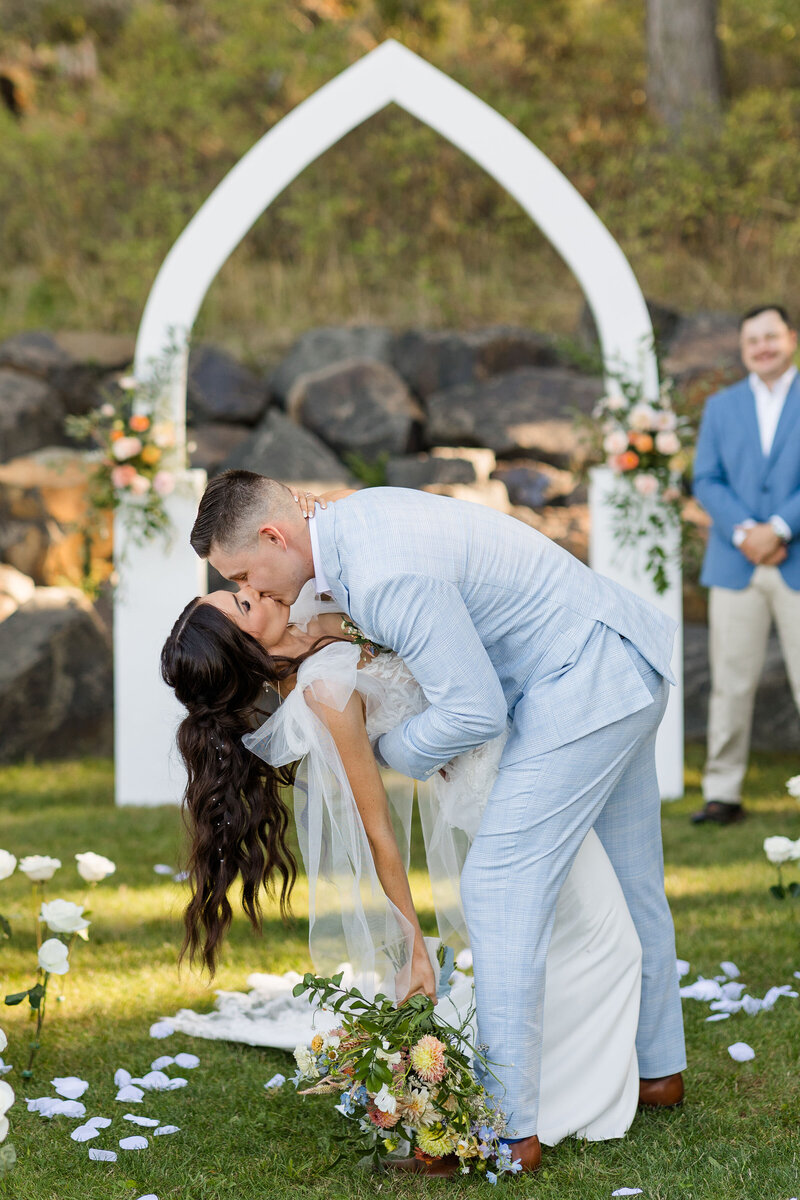 bride and groom sharing a kiss after ceremony at twin creeks farm in idaho