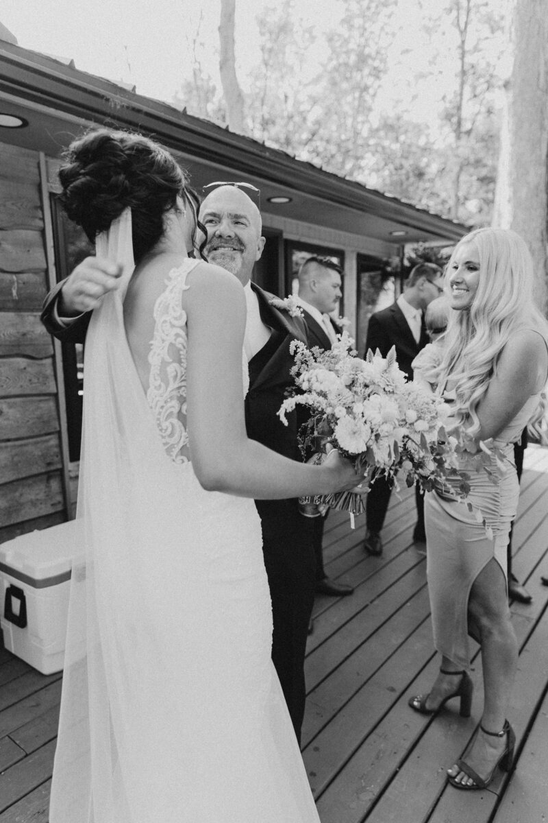 Authentic moment of bride hugging loved one on wedding day, ideal for couples seeking storytelling wedding photography in Michigan or Ohio.