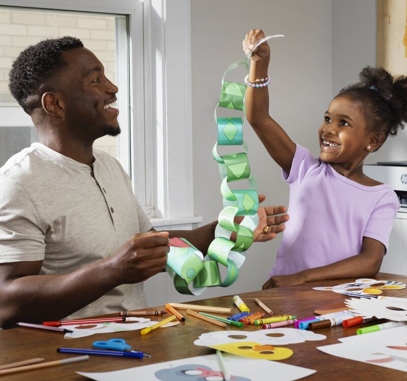 HP Smart Tank kid holding paper snake
