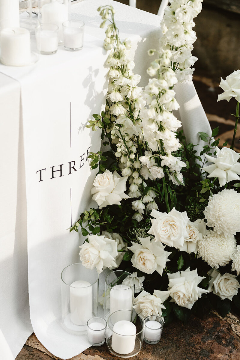 Woman  setting up table with flowers and candles