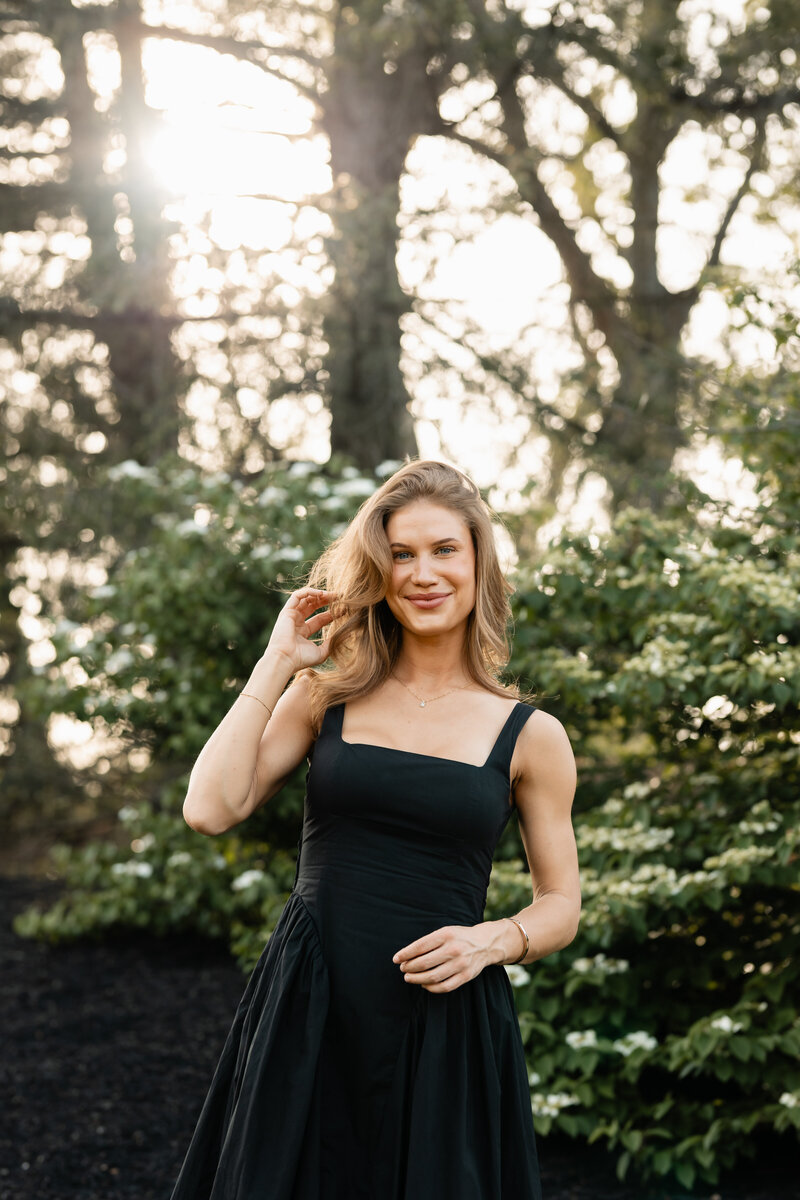 Graduate posing in cap and gown, celebrating their college graduation with joyful and proud moments captured in a timeless portrait.