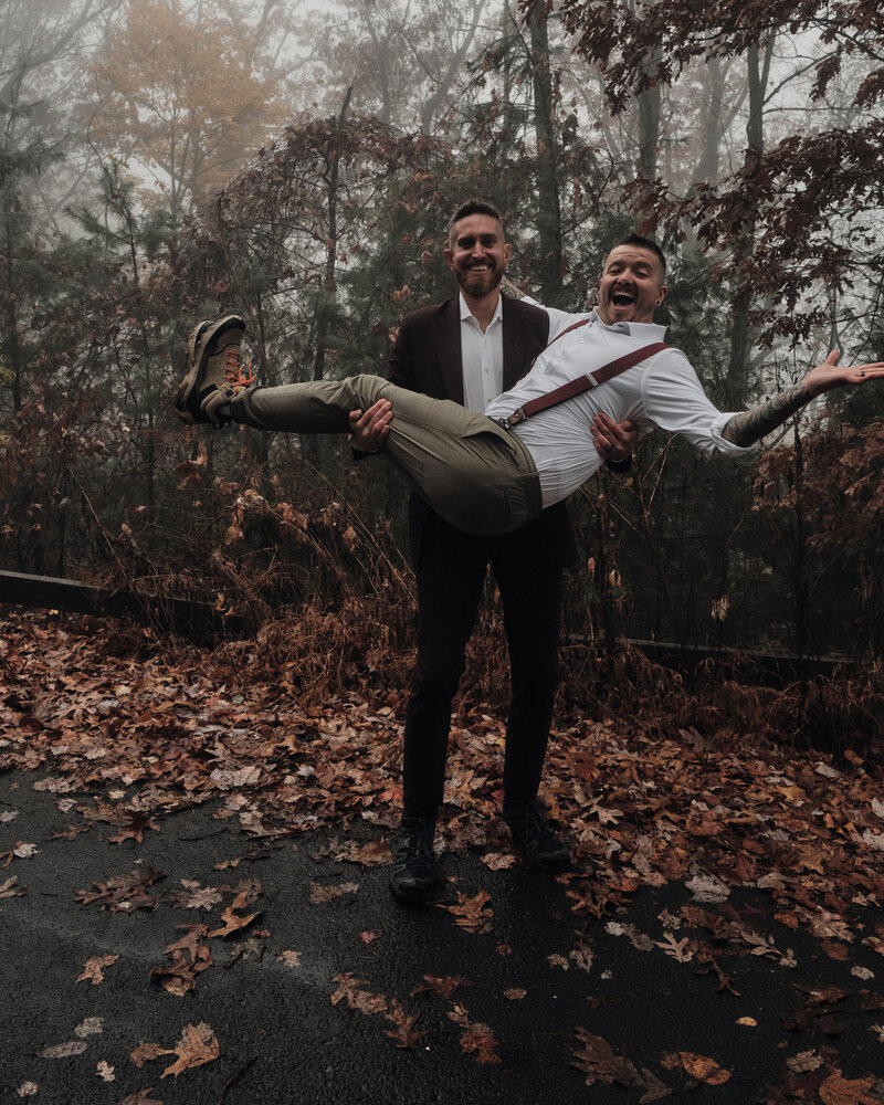 Husbands celebrating their new marriage in the fall leaves