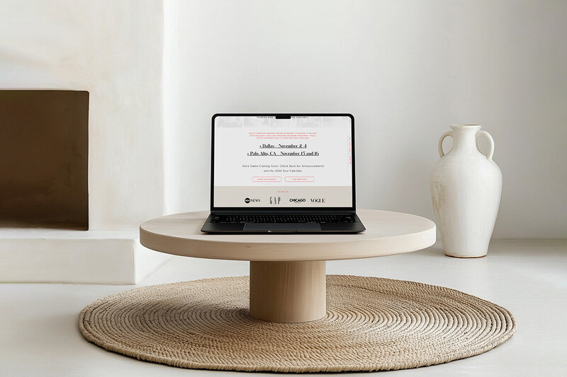 Laptop placed on a round table, showcasing a clean and modern workspace mockup.