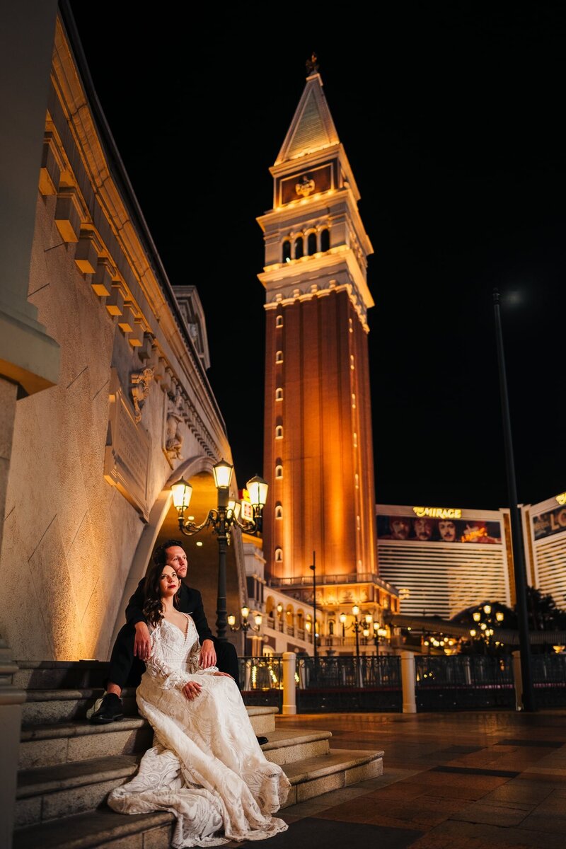Couple sitting on the stairs enjoying the view of the Las Vegas strip during their elopement.
