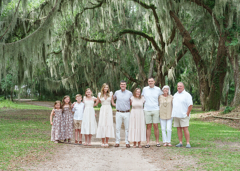 extended family photographed on st simons island at fort frederica against the live oak trees and spanish moss