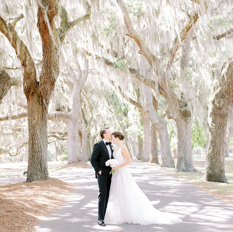 Elopement Photographer, A bride and groom stand near to each other under a grove of trees