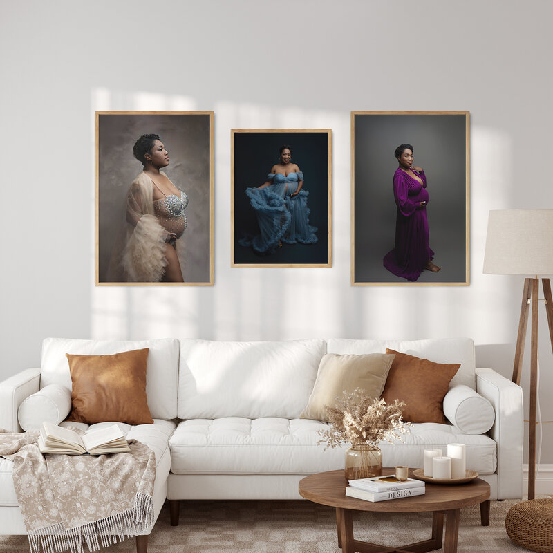 Three fine art maternity  photos hand on a wall above a couch