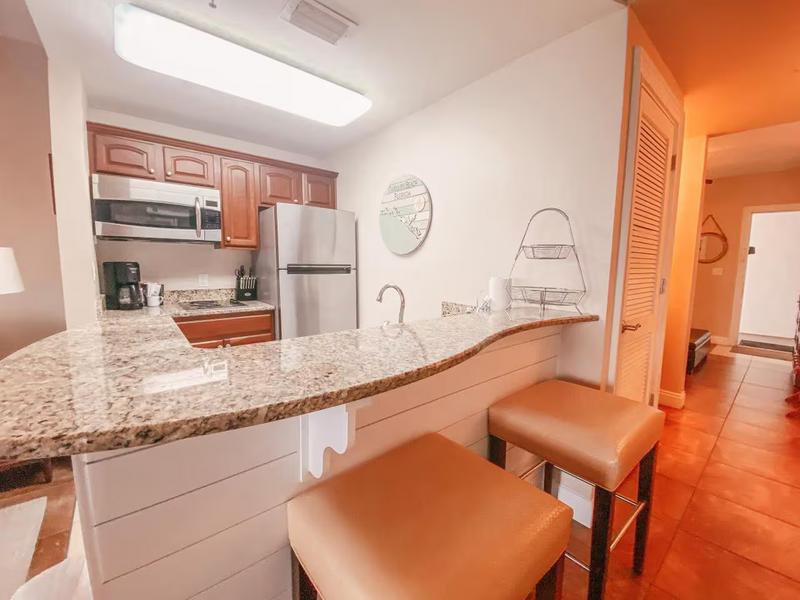 kitchen with bar island and brown bar stools