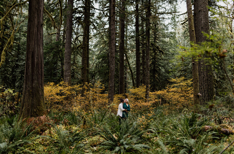 Bride and groom standing in a lush, green forest, showcasing an enchanting moment captured by an Oregon Coast Elopement and Wedding
