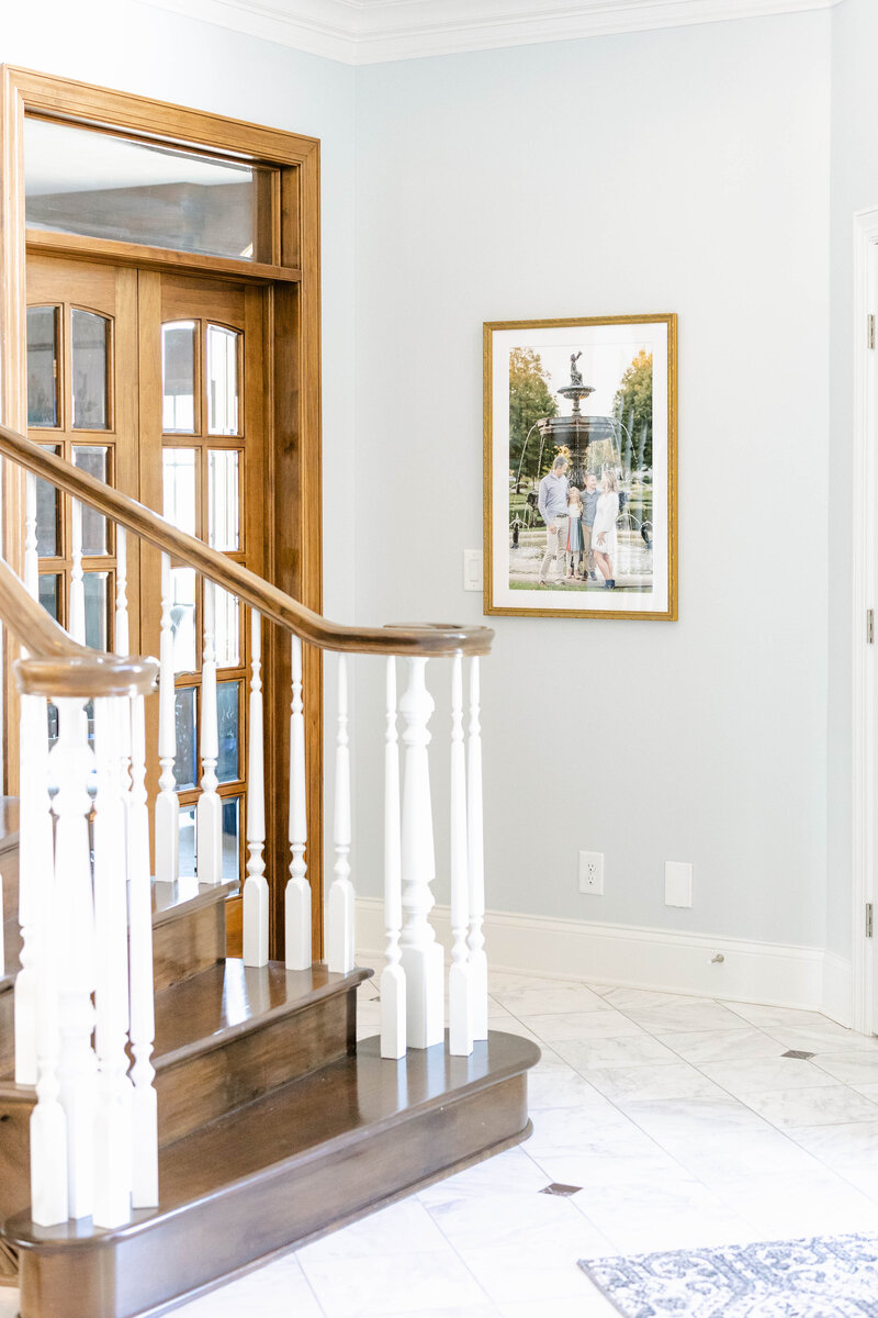 framed family portrait hanging on entryway wall