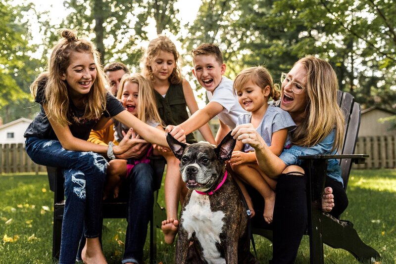 family laughing with dog