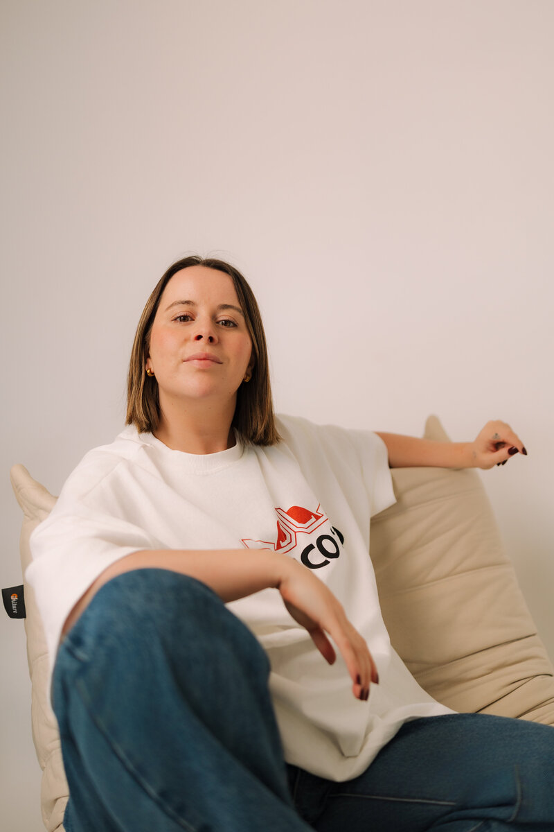 Liv Rollings sitting on a cream colored chair
