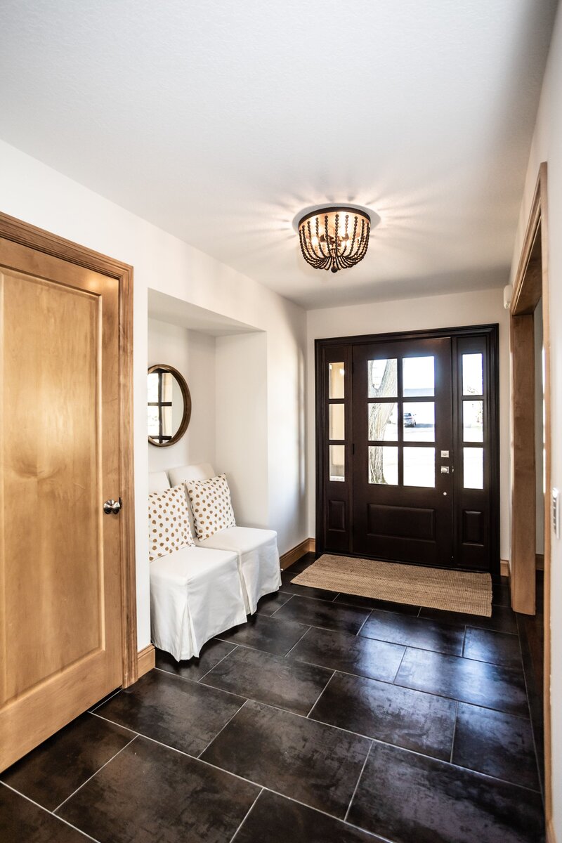 Whole Home Renovation Entryway Design with Black Tile, Light Oak and Beaded Light Fixture