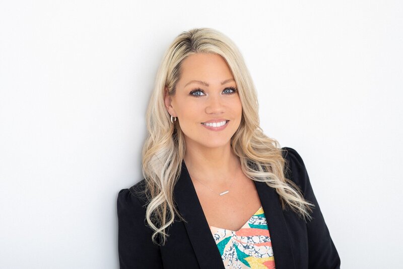 woman with blonde hair a colorful top and a black blazer jacket during her Philadelphia headshot session