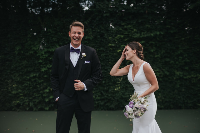 bride and groom laughing at their wedding