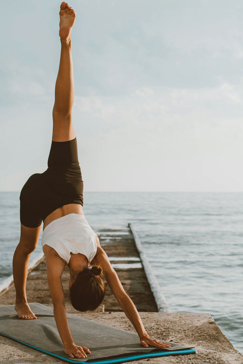 woman stretching by the water