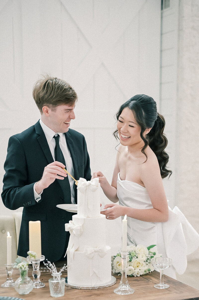 Dallas-Fort Worth Wedding Photographer | DFW Photographer Rae De Lain Weddings Light and Airy | Bride and groom cake slicing at The Farm at Ruth's Nest