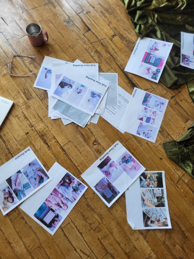 Branding and collateral design layouts spread on wooden floor with style guides and visuals