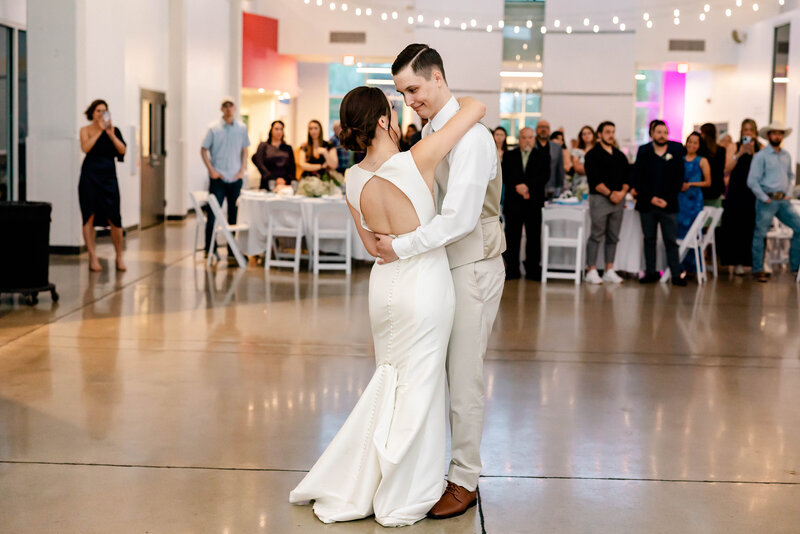 Emotional first dance as Mr. and Mrs. captured by Style & Grace Photography at the St. Charles Foundry in St. Charles, MO, highlighting the couple’s love and joy during their wedding reception.