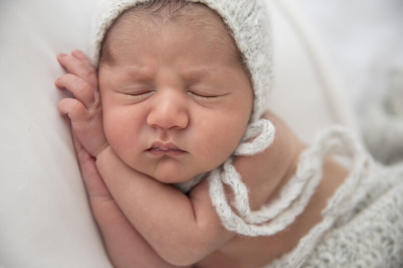 Newborn baby with bonnet