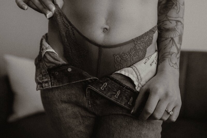 woman's torso in laze underwear and jeans