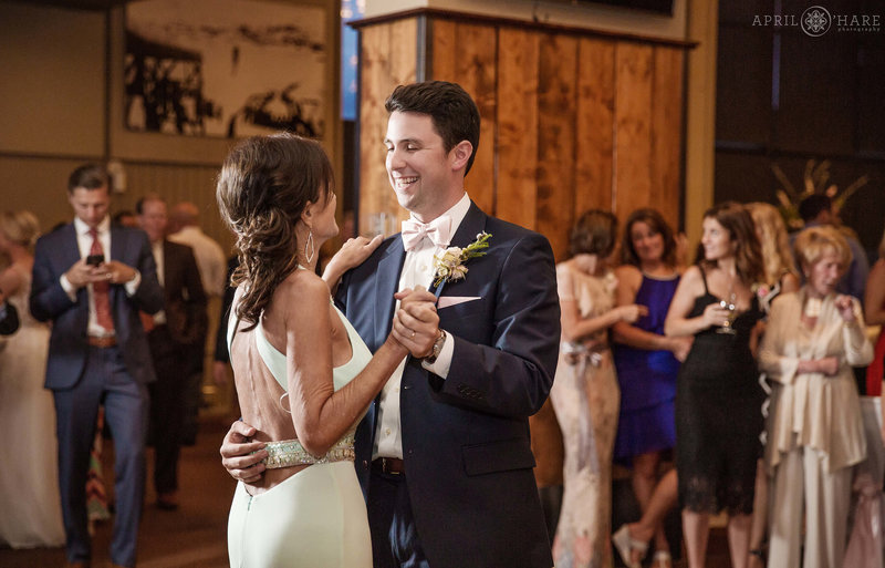Groom dances with his mom at Champagne Powder Room wedding reception in Steamboat Springs
