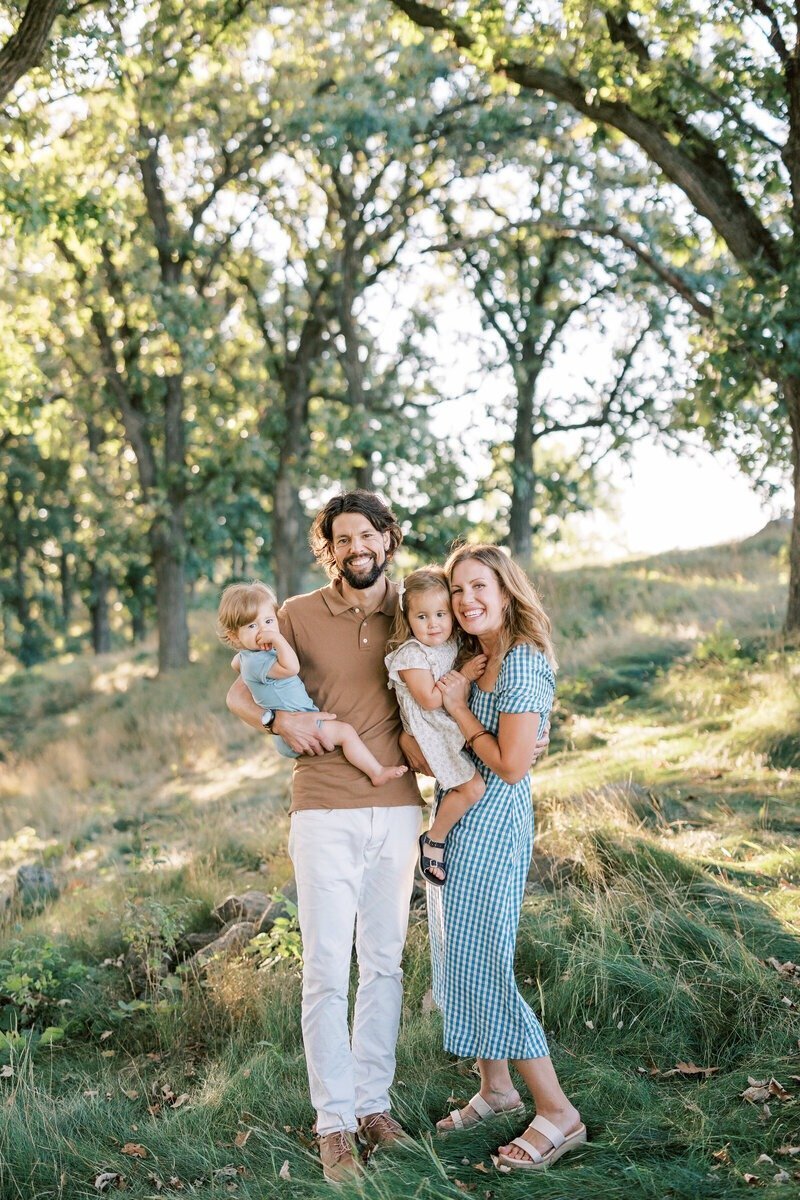 A beautiful family portrait taken in a forest setting by Emily Barbara, family photographer in Milwaukee.