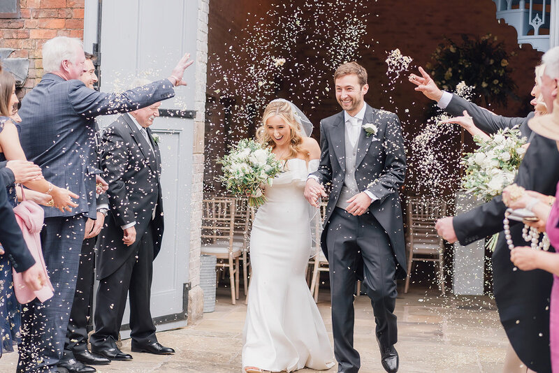 Bride and groom having confetti at Dorfold hall