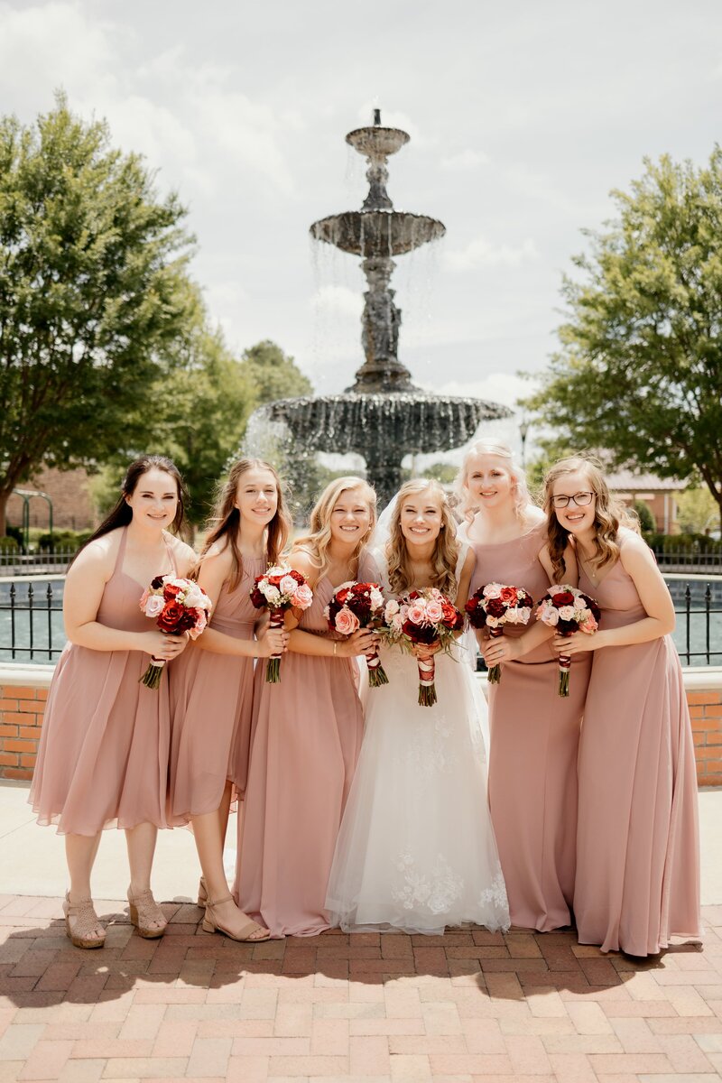 Bride poses with bridesmaids in downtown Murfreesboro
