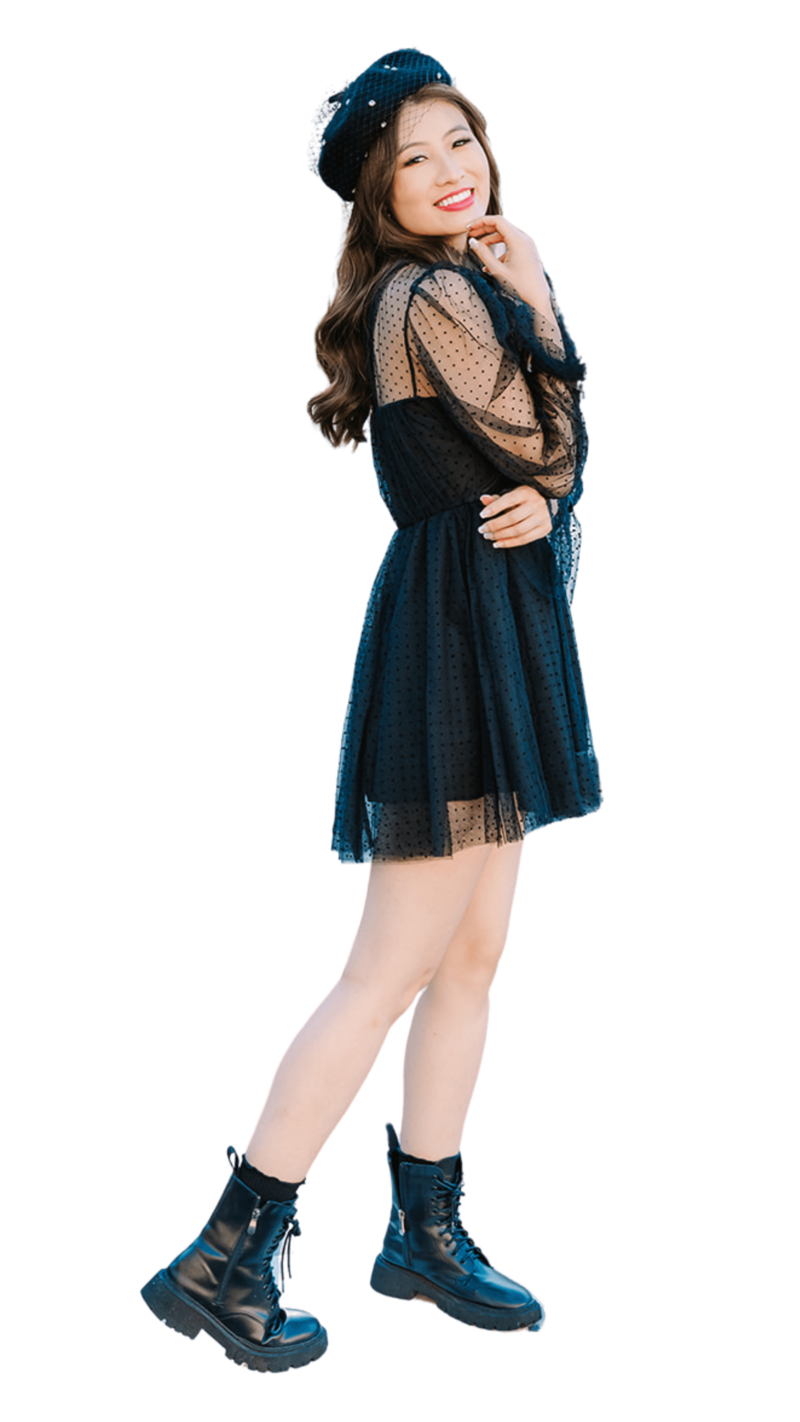 Stylish solo woman wearing a French beret, dress, and Doc Martens during a Paris photoshoot near the Eiffel Tower, Louvre, and Palais Royal.