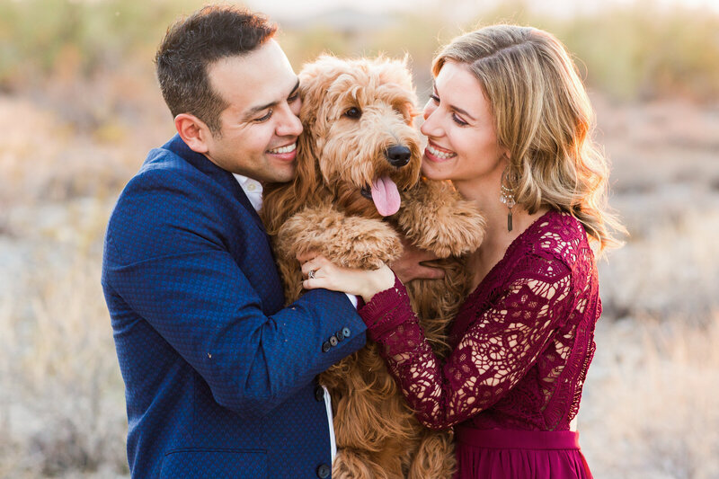 family crouching and smiling at the camera together