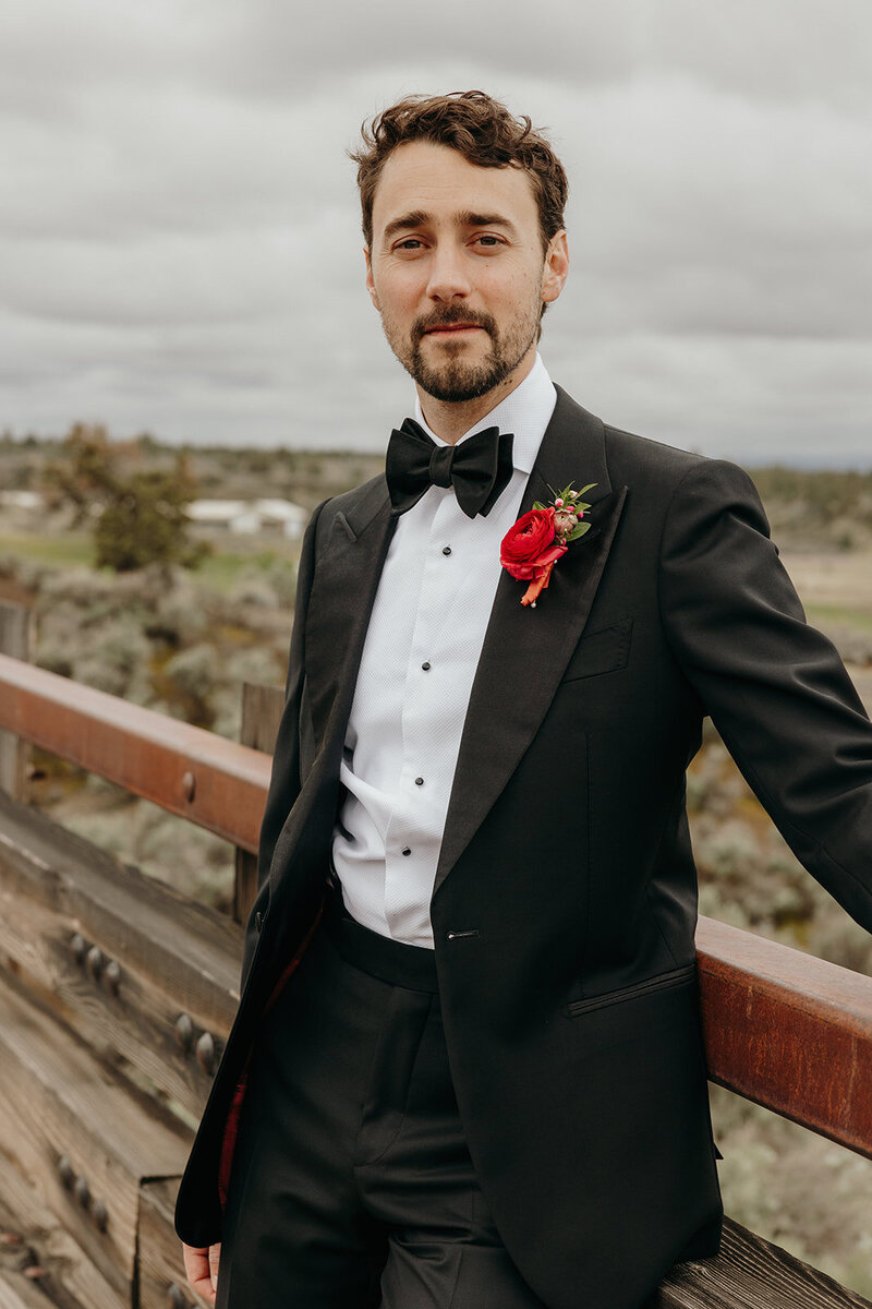 Colorful boutonniere with ranunculus and fuchsia accent