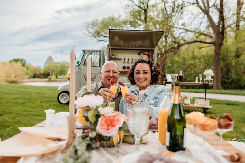 Couple enjoying drinks in front of Bee Tapped Dry Bar beverage truck in Milwaukee