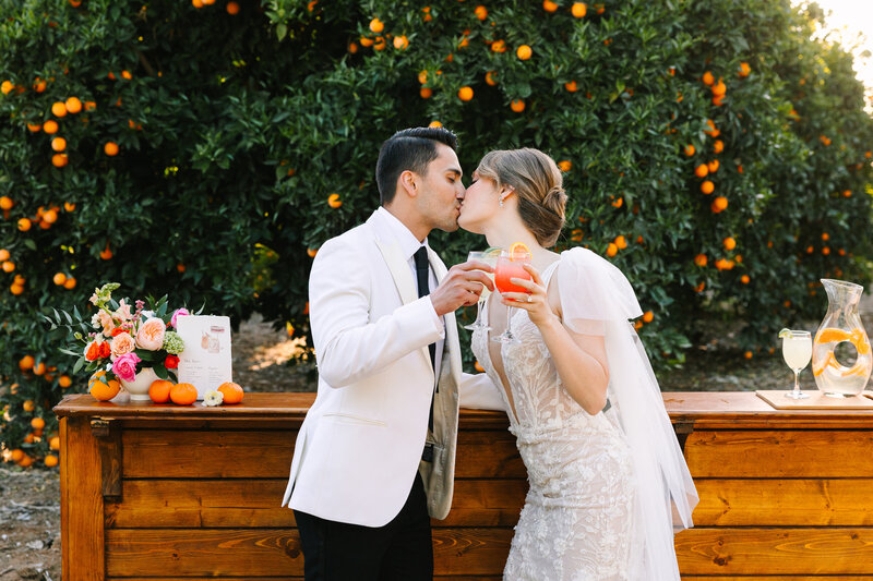 couple cheers and kissing on their wedding day