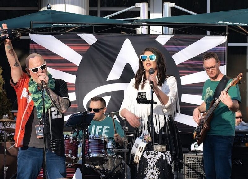 A band performing on a small stage 