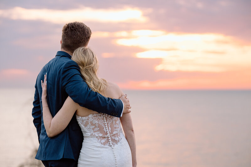 Bride and groom walking in Ash Cave.