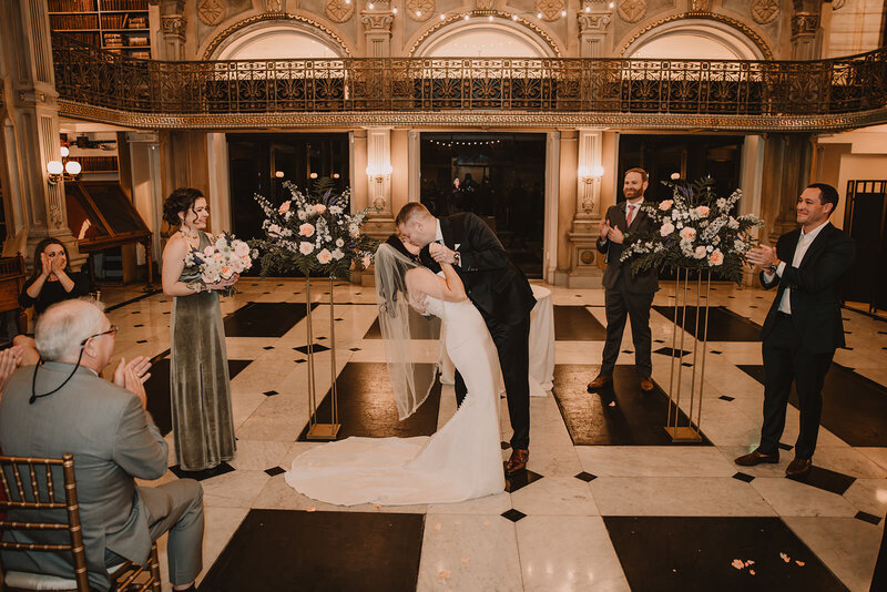 A newlywed couple during their first kiss 