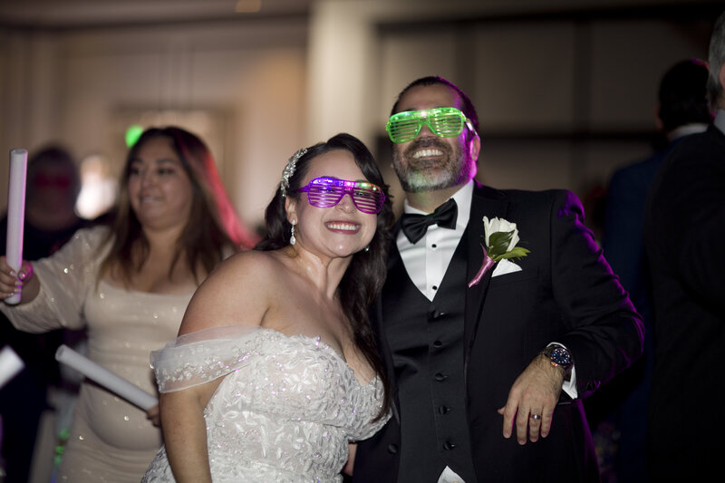bride and groom pose-wedding reception-party glasses-robin rogers photography
