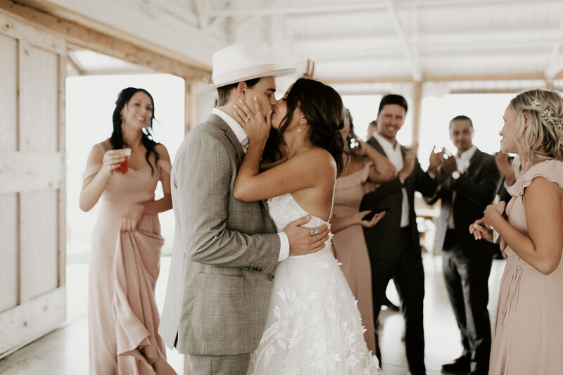Bride and groom kissing on the dance floor of their wedding reception