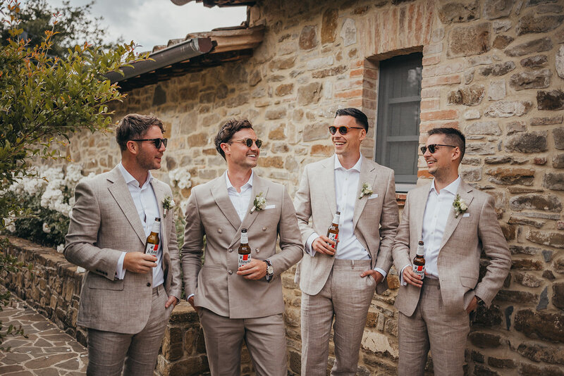 groomsmen share a beer together