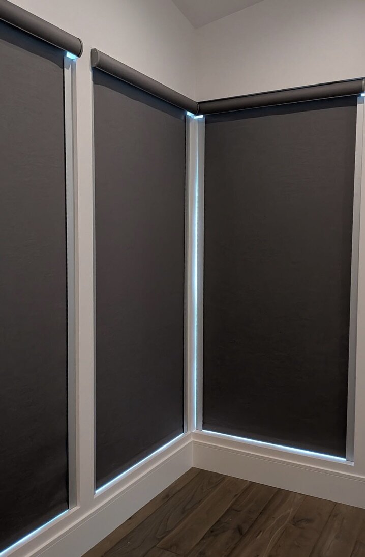 Room-darkening roller shades on corner windows in a Park City, Utah live/work space