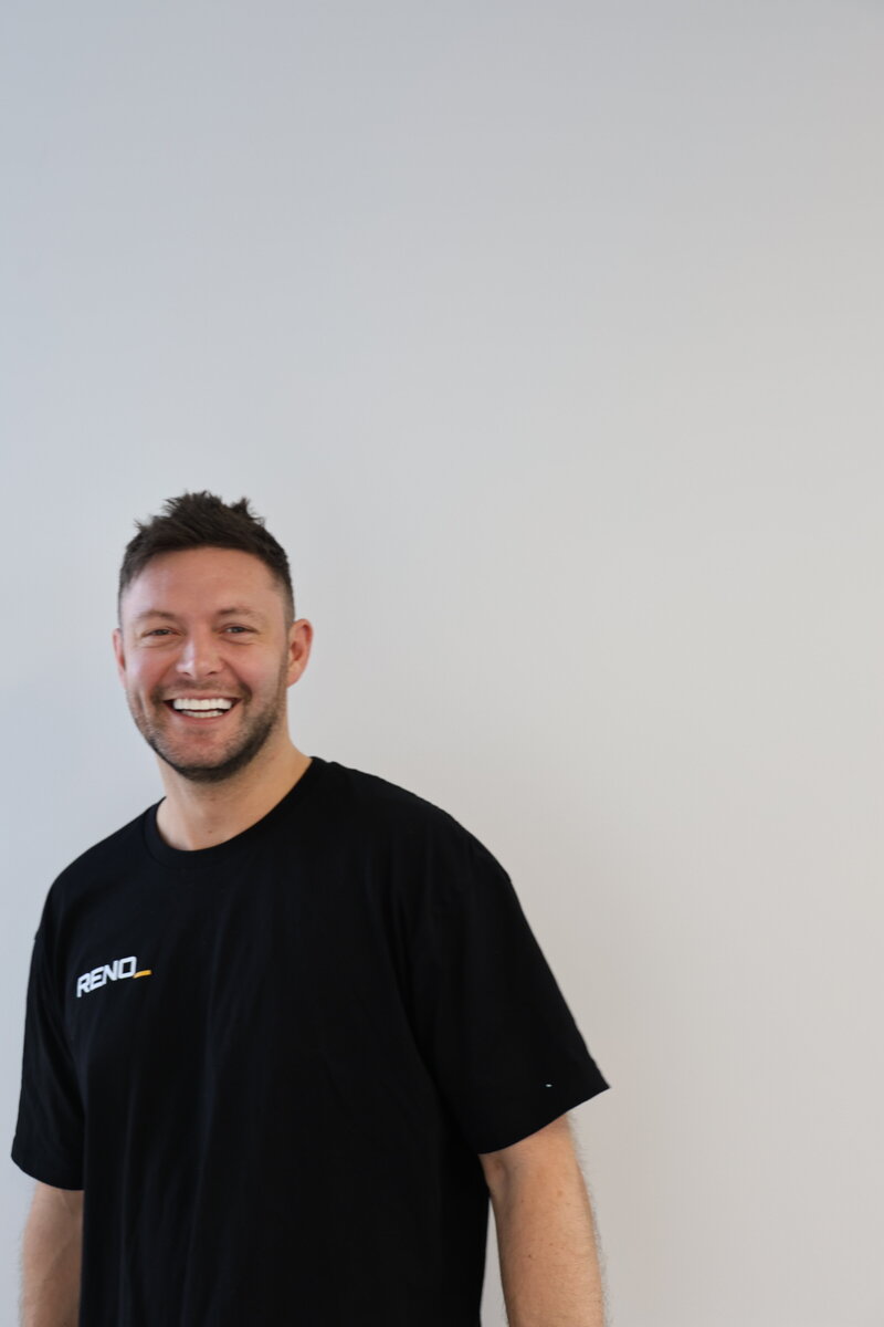 smiling employee with reno space t-shirt on