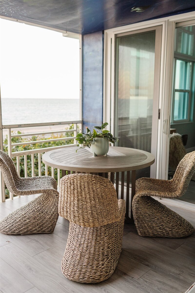 Wicker patio chairs with wooden outdoor table