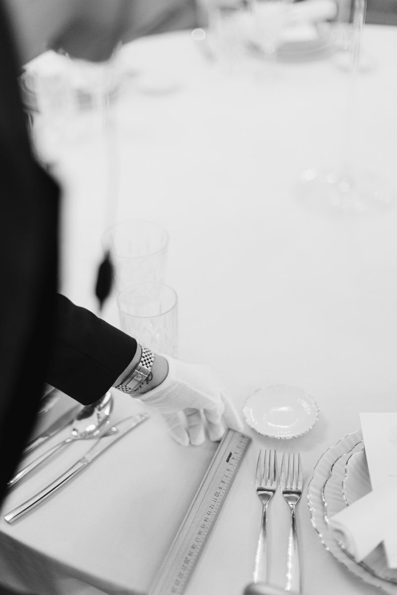 Michaela by ECLAT Destination weddings measuring the distance between the table and cutlery as every detail is important.
