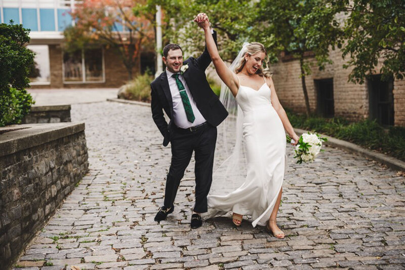 Bride and groom walking into Raleigh wedding reception
