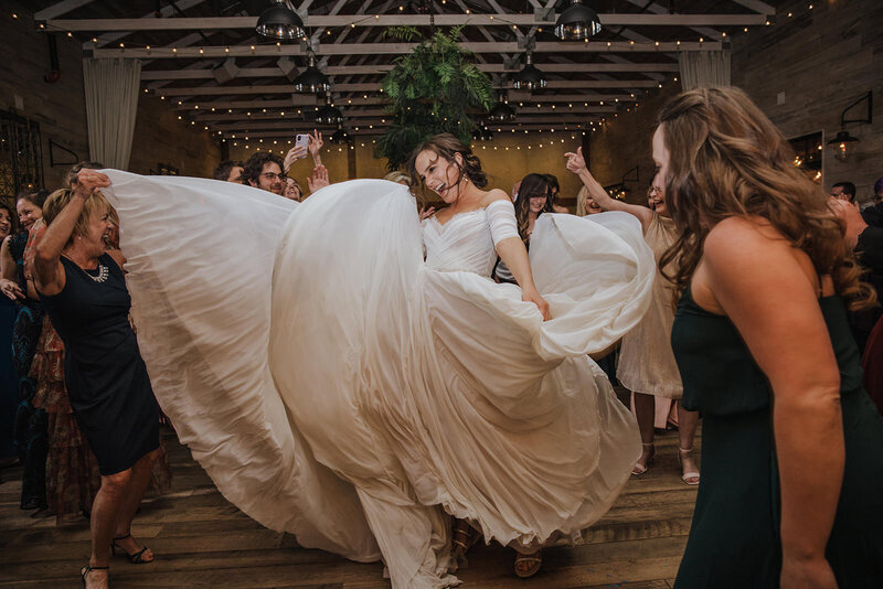 A newlywed dancing and twirling their dress around